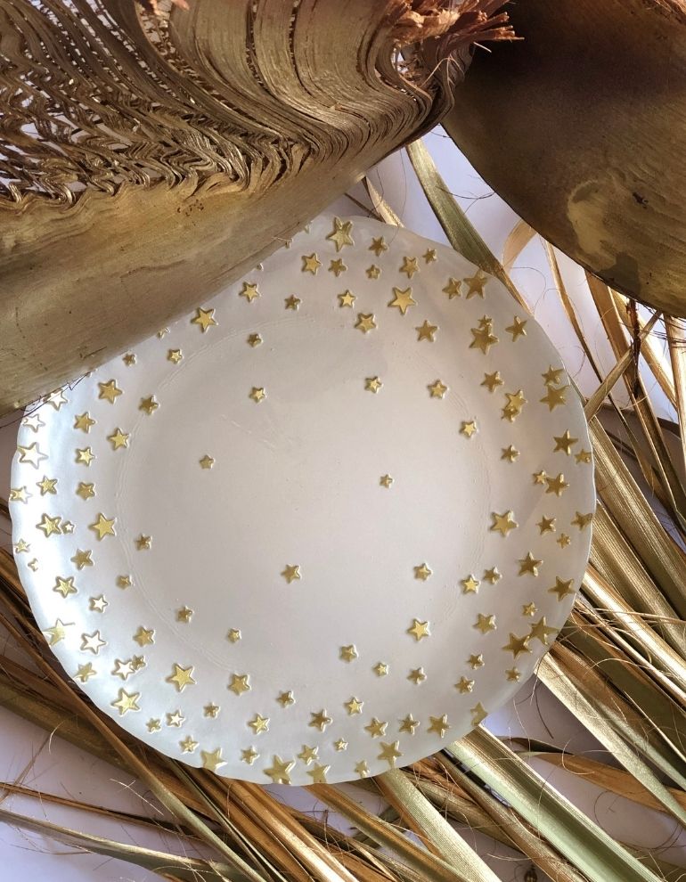 Pearl glass plate with scattered gold stars